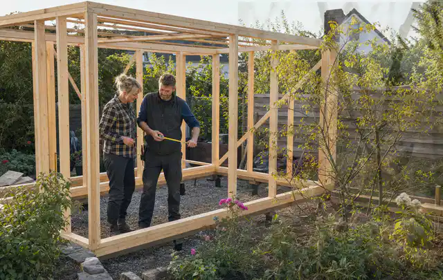 Person plant den Bau eines Gartenhauses auf einer vorbereiteten Fläche; Thema Gartenhaus aus Kunststoff, Schwerpunkt Fehlerhilfe; Ergebnis.