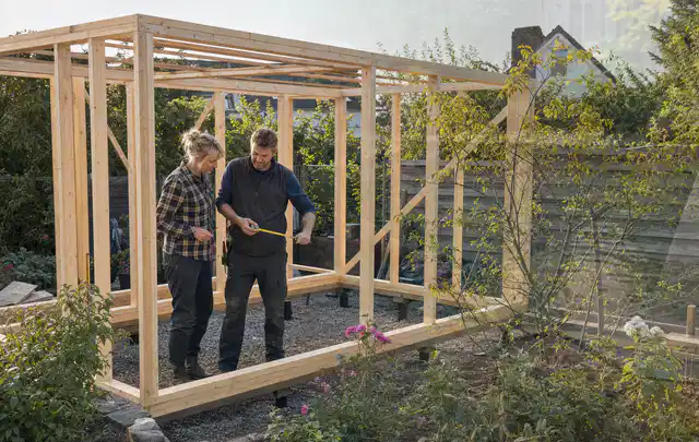 Person plant den Bau eines Gartenhauses auf einer vorbereiteten Fläche; Thema Gartenhaus aus Kunststoff, Schwerpunkt Nachhaltigkeit; Ergebnis.