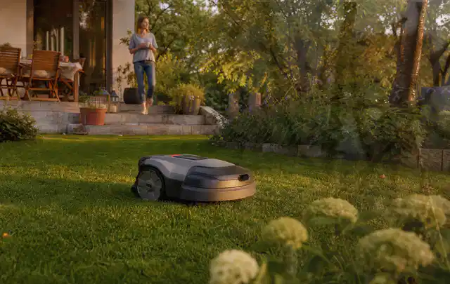 Mähroboter fährt am Abend über einen Rasen im Familiengarten; Thema Kress Mission, Schwerpunkt Ersatzteile; Umsetzung.