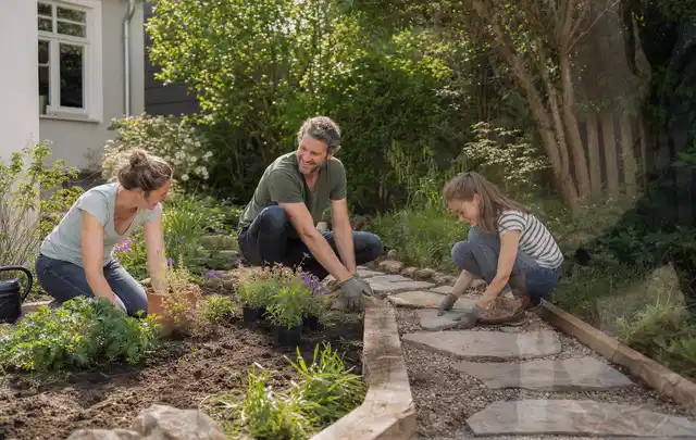 Familie geht auf einem Weg durch einen abwechslungsreich gestalteten Garten; Thema Mediterraner Garten, Schwerpunkt gestalten; Ausgangslage.