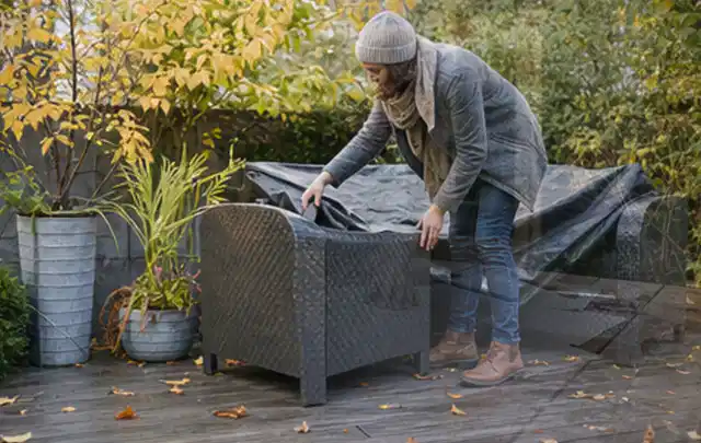 Person deckt Gartenmöbel vor der kalten Jahreszeit sorgfältig ab; Thema Poolfilter, Schwerpunkt Vergleich; Ergebnis.